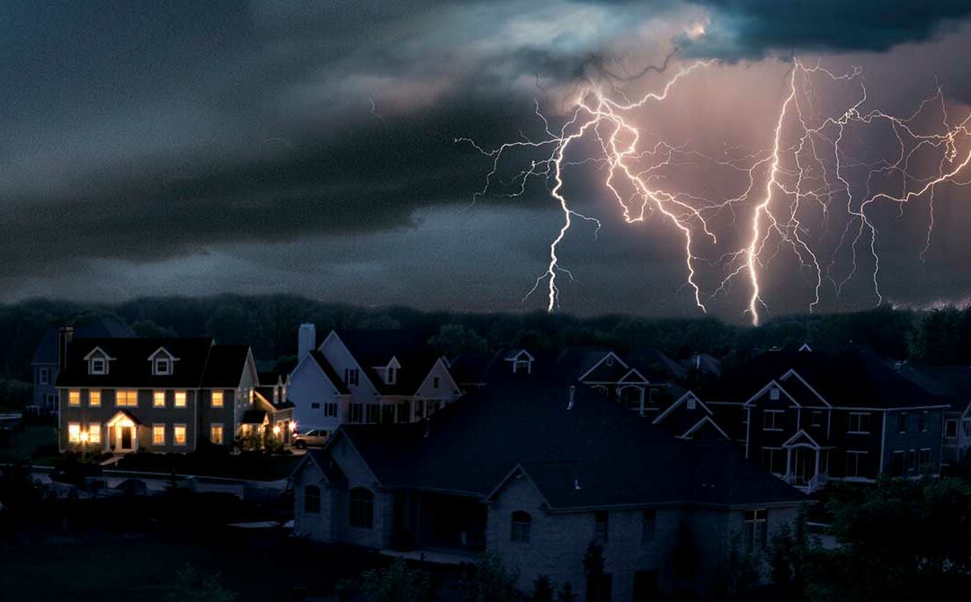 One home has power amid a neighborhood darkened by a power outage in a strong lightning storm